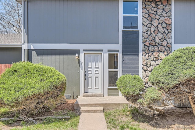 entrance to property featuring stone siding