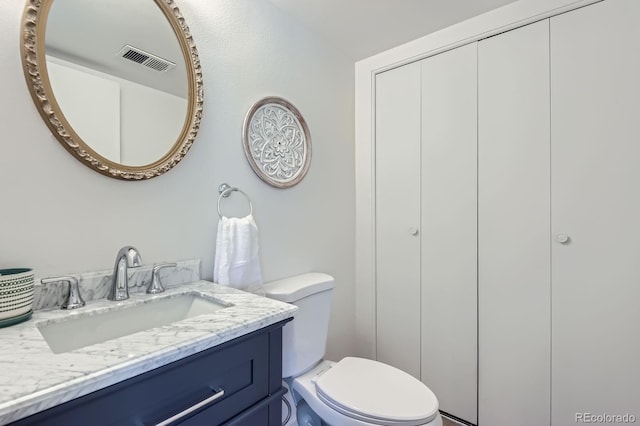 bathroom featuring toilet and vanity