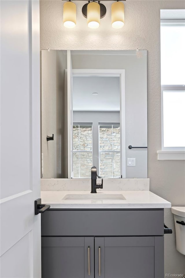 bathroom featuring toilet and vanity