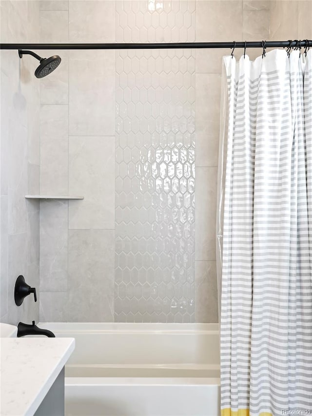 bathroom featuring shower / tub combo and vanity