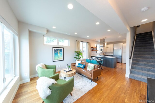 1355 Zenobia St, Denver, CO 80204 - living room with stairs, recessed lighting, light wood-style flooring, and baseboards