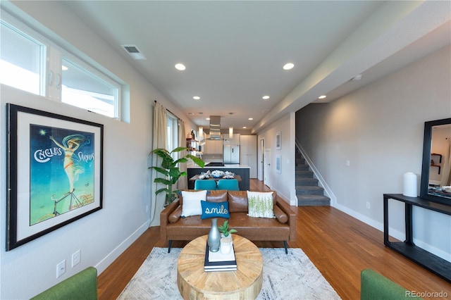 1355 Zenobia St, Denver, CO 80204 - living area featuring recessed lighting, wood finished floors, baseboards, and stairs