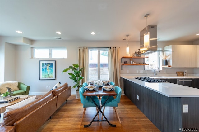 1355 Zenobia St, Denver, CO 80204 - kitchen with open floor plan, a sink, light countertops, island exhaust hood, and recessed lighting