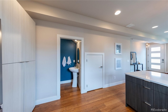 1355 Zenobia St, Denver, CO 80204 - kitchen with modern cabinets, baseboards, light wood-style flooring, light countertops, and recessed lighting