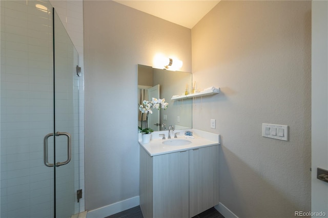 1355 Zenobia St, Denver, CO 80204 - bathroom with vanity, a stall shower, and baseboards