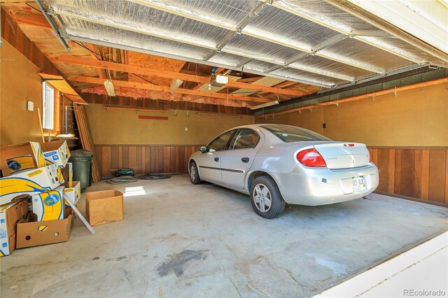 3354 W Arlington Ave, Littleton, CO 80123 - garage featuring wood walls, wainscoting, and a garage door opener