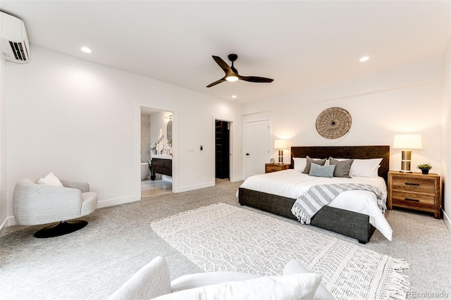 bedroom with ensuite bath, a wall mounted AC, light carpet, a closet, and ceiling fan