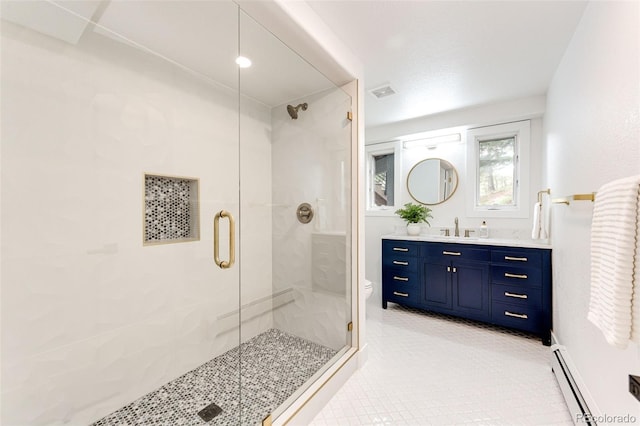 bathroom featuring a baseboard radiator, vanity, toilet, and an enclosed shower