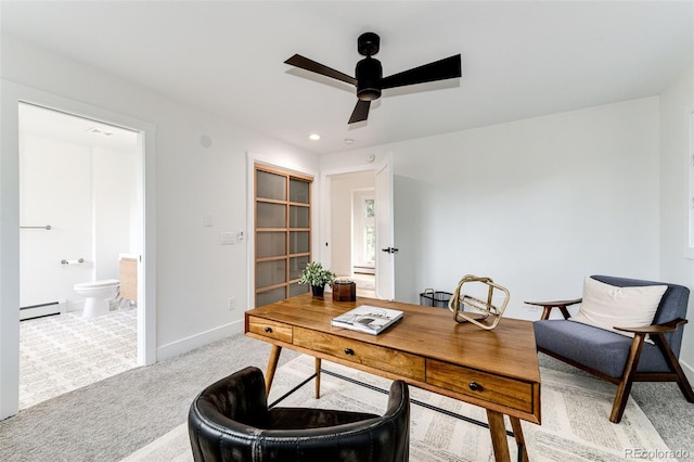 carpeted office space with ceiling fan and a baseboard radiator