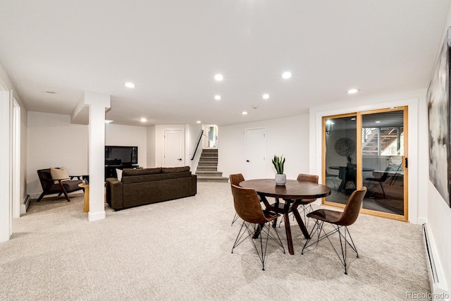 carpeted dining room with a baseboard radiator