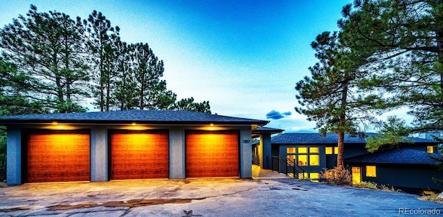 view of front of house featuring a garage and an outdoor structure