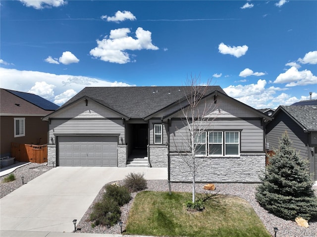 ranch-style home featuring stone siding, a garage, and driveway