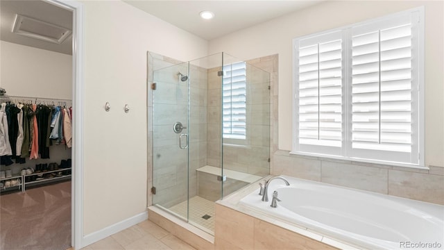 bathroom with a spacious closet, a garden tub, a shower stall, and tile patterned floors