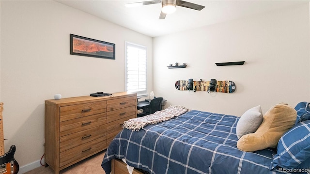 bedroom featuring light carpet, baseboards, and a ceiling fan