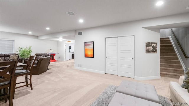 living area with light carpet, visible vents, recessed lighting, and stairway