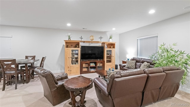 living room with recessed lighting and light colored carpet