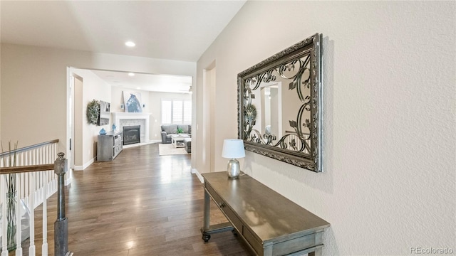 hall with dark wood-type flooring, recessed lighting, and baseboards