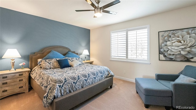 carpeted bedroom with baseboards and a ceiling fan