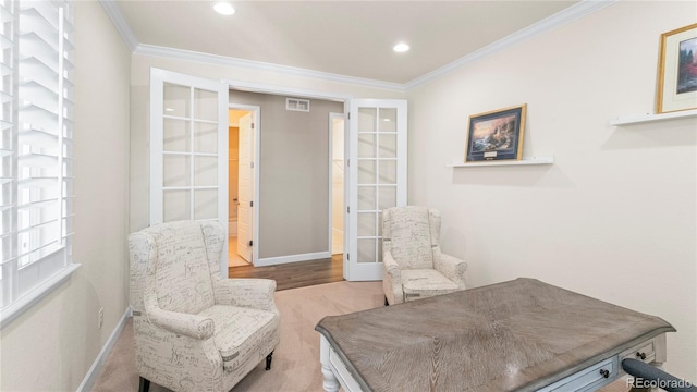 sitting room with baseboards, ornamental molding, french doors, and visible vents