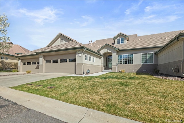 ranch-style house with a tiled roof, driveway, a front yard, an attached garage, and stucco siding