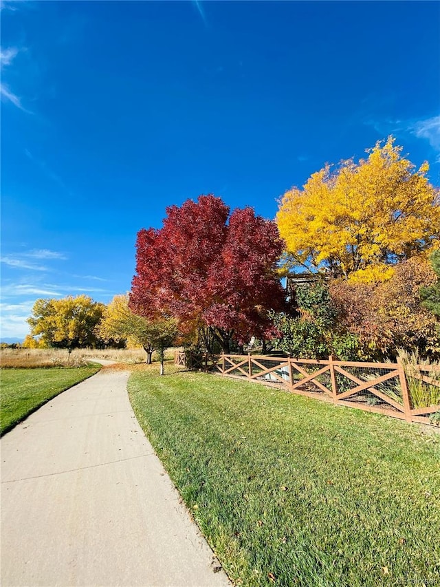 surrounding community featuring a lawn and fence