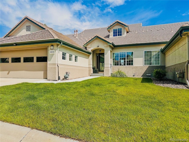 3425 W 111th Loop Unit B, Westminster, CO 80031 - view of front facade with stucco siding, a front lawn, a tile roof, and an attached garage