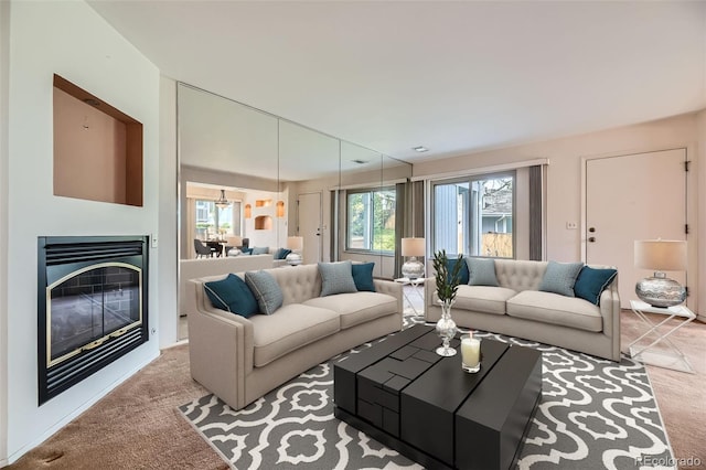 carpeted living area with a glass covered fireplace