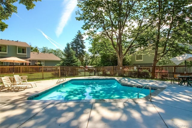 view of pool with a patio area, a fenced in pool, and fence