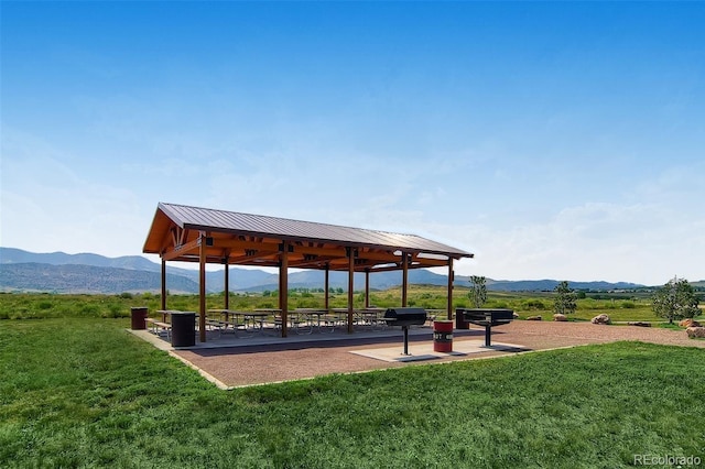 view of community with a gazebo, a mountain view, and a lawn