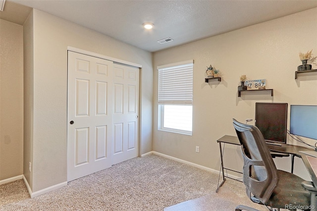 carpeted home office with baseboards and visible vents