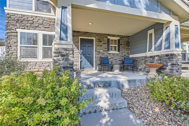 1133 S Richfield St, Aurora, CO 80017 - property entrance featuring stone siding and covered porch