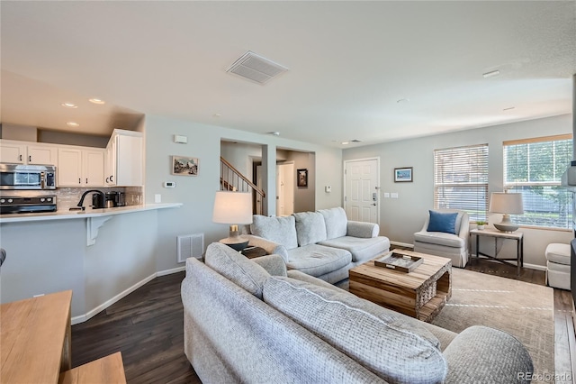 1133 S Richfield St, Aurora, CO 80017 - living area featuring dark wood-style floors, stairs, and recessed lighting