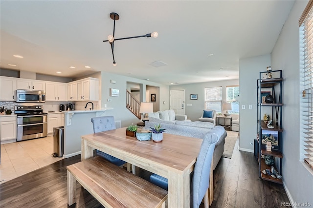 1133 S Richfield St, Aurora, CO 80017 - dining space featuring stairs, light wood-type flooring, and recessed lighting