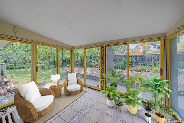 sunroom / solarium featuring vaulted ceiling and a wealth of natural light