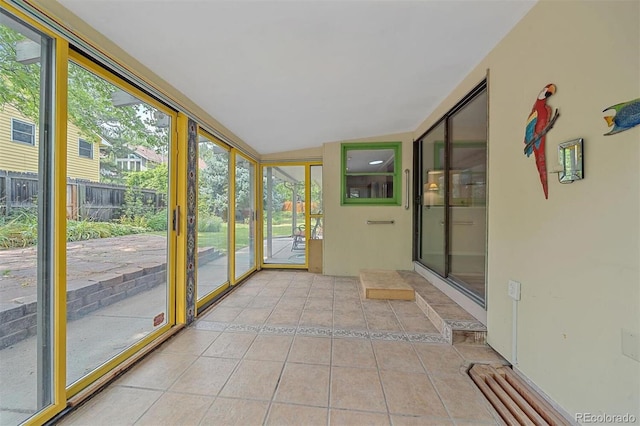 unfurnished sunroom with lofted ceiling