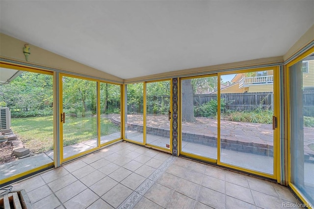 unfurnished sunroom featuring vaulted ceiling