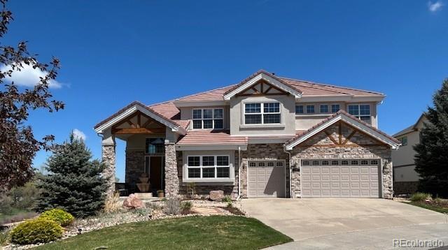 craftsman-style house with stone siding, concrete driveway, an attached garage, and stucco siding