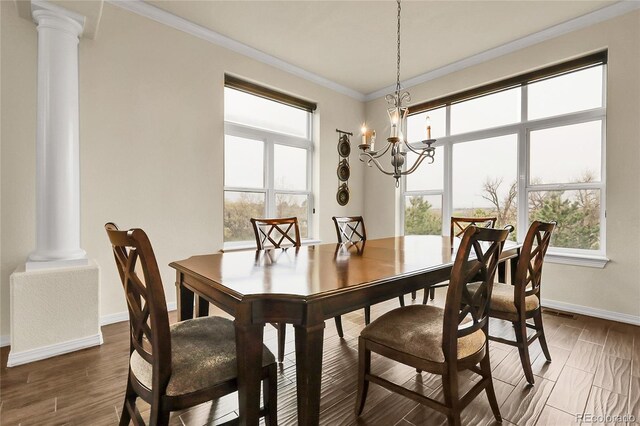 dining room with ornate columns, a chandelier, ornamental molding, baseboards, and healthy amount of natural light