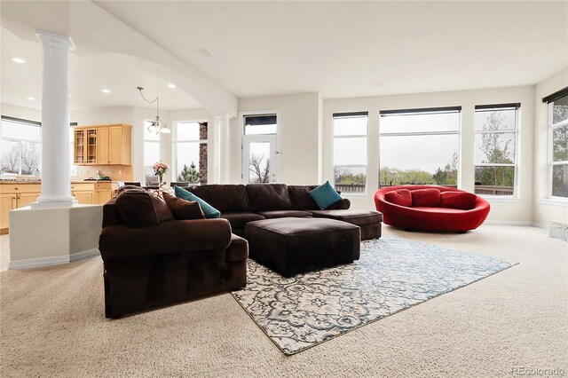 living room featuring ornate columns, light carpet, and recessed lighting