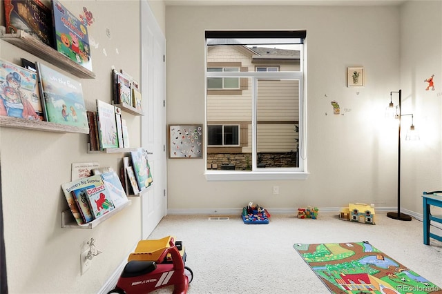 rec room with carpet and baseboards