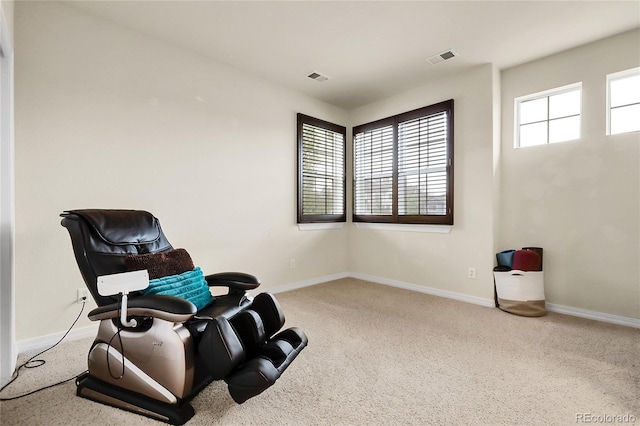 living area featuring carpet flooring and baseboards