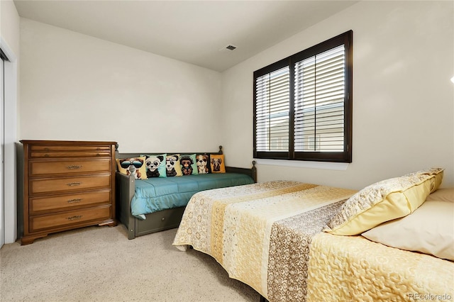 bedroom featuring light carpet
