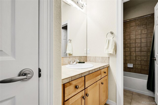 bathroom featuring tile patterned floors, vanity, and shower / tub combination