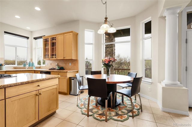 23965 E Kettle Pl, Aurora, CO 80016 - dining space with ornate columns, plenty of natural light, recessed lighting, and light tile patterned floors