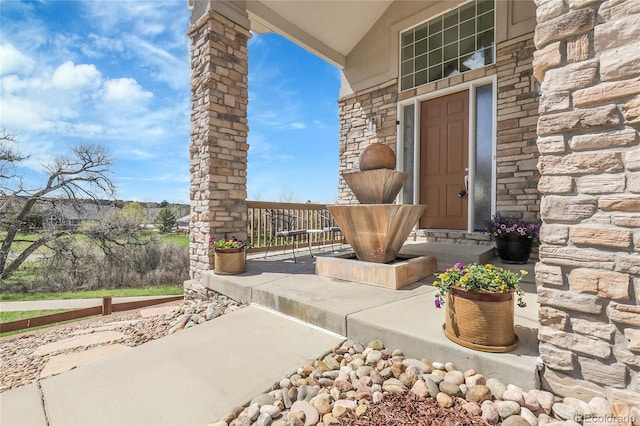 23965 E Kettle Pl, Aurora, CO 80016 - doorway to property featuring stone siding and a porch