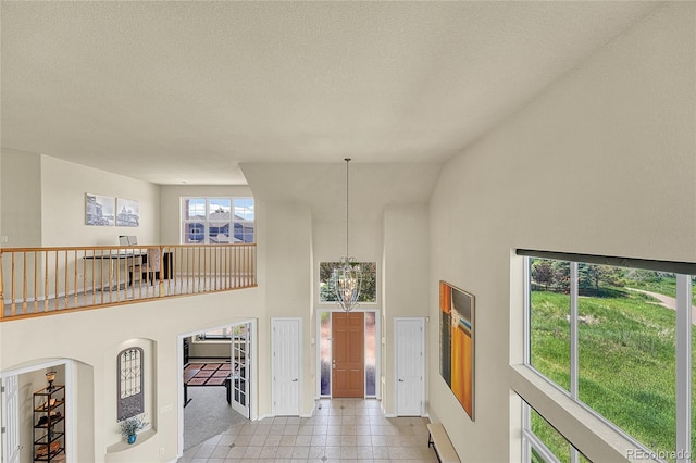 23965 E Kettle Pl, Aurora, CO 80016 - foyer entrance with high vaulted ceiling and a textured ceiling