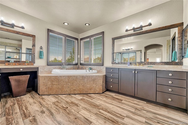 23965 E Kettle Pl, Aurora, CO 80016 - full bathroom with a bath, vanity, wood finished floors, a textured wall, and an enclosed shower