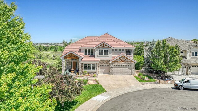 23965 E Kettle Pl, Aurora, CO 80016 - view of front facade featuring stone siding, a tile roof, and concrete driveway