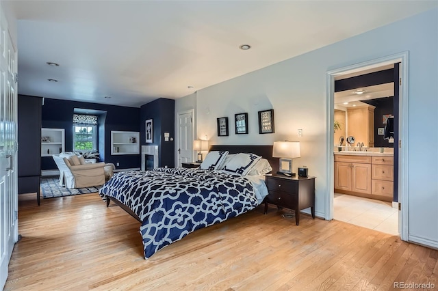 824 S Medea Way, Denver, CO 80209 - bedroom featuring light wood finished floors, a sink, and ensuite bathroom