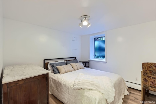 824 S Medea Way, Denver, CO 80209 - bedroom with baseboard heating and wood finished floors